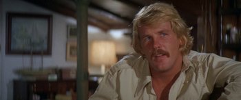 Movie still from “The Deep” (1977), directed by Peter Yates – A person wearing a shirt; Close Up shot, Low angle