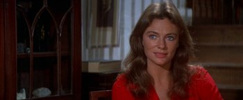 Movie still from “The Deep” (1977), directed by Peter Yates – A woman in a red shirt sitting at a table; Close Up shot, Over the shoulder angle