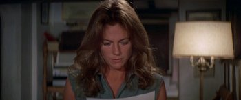 Movie still from “The Deep” (1977), directed by Peter Yates – A person with long brown hair; Close Up shot, High angle