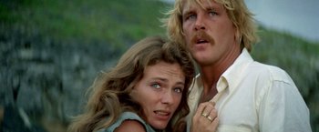 Movie still from “The Deep” (1977), directed by Peter Yates – A man and a woman standing next to each other; Close Up shot, Low angle