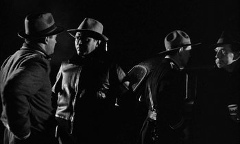 Movie still from “The Defiant Ones” (1958), directed by Stanley Kramer – A group of men wearing hats and leather jackets; Medium shot, Low angle
