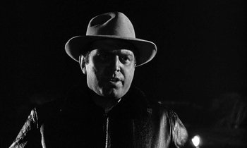 Movie still from “The Defiant Ones” (1958), directed by Stanley Kramer – A black and white photo of a man wearing a hat; Close Up shot, Low angle