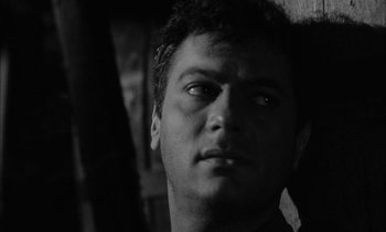 Movie still from “The Defiant Ones” (1958), directed by Stanley Kramer – Black and white photograph of a man looking into the distance; Close Up shot, Low angle