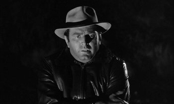 Movie still from “The Defiant Ones” (1958), directed by Stanley Kramer – A black and white photo of a man wearing a hat; Close Up shot, Low angle