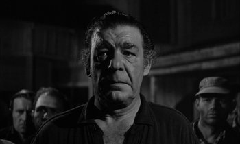 Movie still from “The Defiant Ones” (1958), directed by Stanley Kramer – An older man in a black and white photo; Close Up shot, Low angle