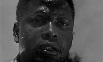 Movie still from “The Defiant Ones” (1958), directed by Stanley Kramer – A man's face in black and white; Close Up shot, Low angle