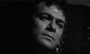 Movie still from “The Defiant Ones” (1958), directed by Stanley Kramer – Black and white photograph of a man looking into the camera; Close Up shot, Low angle