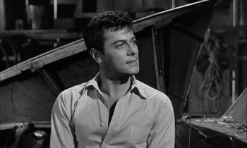 Movie still from “The Defiant Ones” (1958), directed by Stanley Kramer – Black and white photograph of a man in a shirt; Close Up shot, Low angle