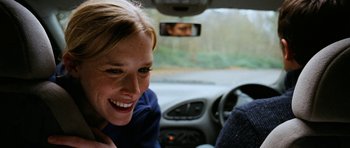 Movie still from “The Descent” (2005), directed by Neil Marshall – A woman sitting in the driver's seat of a car; Close Up shot, Over the shoulder angle