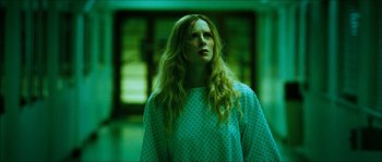 Movie still from “The Descent” (2005), directed by Neil Marshall – A woman with long blonde hair standing in a room; Medium shot, Low angle