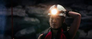 Movie still from “The Descent” (2005), directed by Neil Marshall – A woman wearing a hard hat with a light on her head; Close Up shot, Low angle
