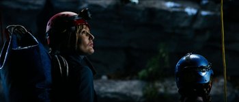 Movie still from “The Descent” (2005), directed by Neil Marshall – A woman wearing a helmet looking up into the sky; Close Up shot, Low angle