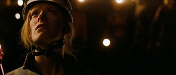 Movie still from “The Descent” (2005), directed by Neil Marshall – A woman wearing a helmet in the dark; Close Up shot, Low angle