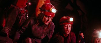 Movie still from “The Descent” (2005), directed by Neil Marshall – A couple of people that are in a cave; Medium shot, Low angle