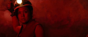 Movie still from “The Descent” (2005), directed by Neil Marshall – A woman in a helmet is posing for a picture; Close Up shot, Low angle