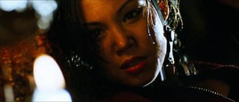 Movie still from “The Descent” (2005), directed by Neil Marshall – A woman's face in the dark; Close Up shot, Low angle