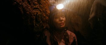 Movie still from “The Descent” (2005), directed by Neil Marshall – A woman with her eyes closed in the rain; Close Up shot, Overhead angle