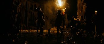 Movie still from “The Descent” (2005), directed by Neil Marshall – A group of people standing next to each other in the dark; Wide shot, Low angle
