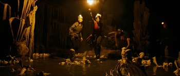 Movie still from “The Descent” (2005), directed by Neil Marshall – A group of people in a cave holding a light; Wide shot, Low angle
