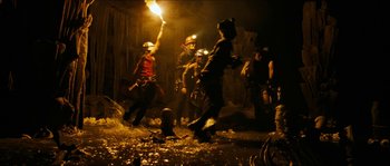 Movie still from “The Descent” (2005), directed by Neil Marshall – A group of people standing next to fire hydrants; Wide shot, High angle