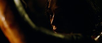 Movie still from “The Descent” (2005), directed by Neil Marshall – A person's face in the dark; Extreme Close Up shot, Over the shoulder angle