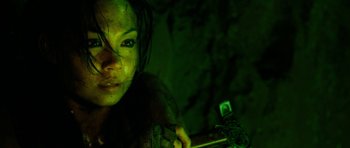 Movie still from “The Descent” (2005), directed by Neil Marshall – A person holding a video game controller; Close Up shot, High angle