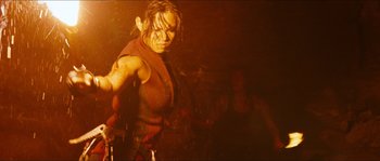 Movie still from “The Descent” (2005), directed by Neil Marshall – A woman in a red shirt is posing for a picture; Medium shot, Low angle