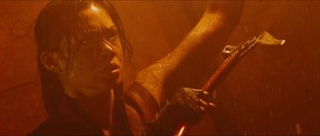 Movie still from “The Descent” (2005), directed by Neil Marshall – A woman is holding a wooden stick in her hand; Close Up shot, Low angle