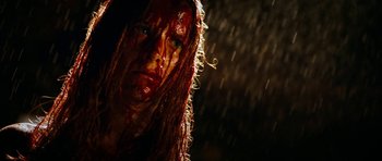 Movie still from “The Descent” (2005), directed by Neil Marshall – A person with blood all over her face; Close Up shot, Low angle