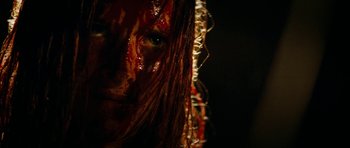 Movie still from “The Descent” (2005), directed by Neil Marshall – A woman's face covered in blood; Extreme Close Up shot, Over the shoulder angle