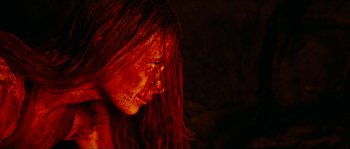 Movie still from “The Descent” (2005), directed by Neil Marshall – A person with long red hair; Close Up shot, Low angle
