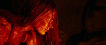 Movie still from “The Descent” (2005), directed by Neil Marshall – A person with blood on their face; Close Up shot, High angle
