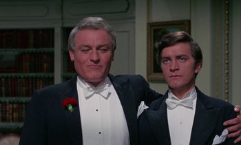 Movie still from “The Devil Rides Out” (1968), directed by Terence Fisher – Two men in tuxedos posing for a picture; Close Up shot, Low angle