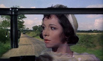 Movie still from “The Devil Rides Out” (1968), directed by Terence Fisher – A woman in a hat looking out the window of a car; Close Up shot, Over the shoulder angle