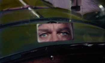 Movie still from “The Devil Rides Out” (1968), directed by Terence Fisher – A man looking at his reflection in a mirror; Close Up shot, Overhead angle