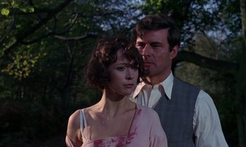 Movie still from “The Devil Rides Out” (1968), directed by Terence Fisher – A man and a woman standing next to each other in front of a tree; Close Up shot, Low angle