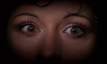 Movie still from “The Devil Rides Out” (1968), directed by Terence Fisher – A woman's eyes with long lashes; Extreme Close Up shot, Overhead angle