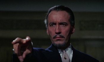 Movie still from “The Devil Rides Out” (1968), directed by Terence Fisher – A person holding an apple; Close Up shot, Low angle