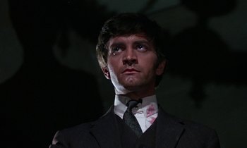 Movie still from “The Devil Rides Out” (1968), directed by Terence Fisher – A man in a suit and tie looking up at the sky; Close Up shot, Low angle