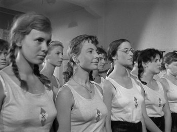 Movie still from “The Devil Strikes at Night” (1957), directed by Robert Siodmak – A black and white photo of a group of women; Medium shot, Low angle
