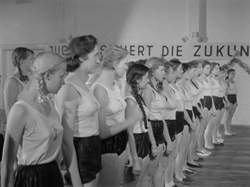 Movie still from “The Devil Strikes at Night” (1957), directed by Robert Siodmak – A group of young women standing next to each other; Wide shot, Low angle