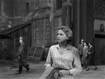 Movie still from “The Devil Strikes at Night” (1957), directed by Robert Siodmak – An old black and white photo of a woman; Medium shot, Low angle