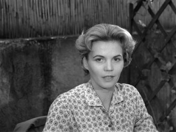 Movie still from “The Devil Strikes at Night” (1957), directed by Robert Siodmak – A black - and - white photo of a woman with short blonde hair; Close Up shot, Low angle