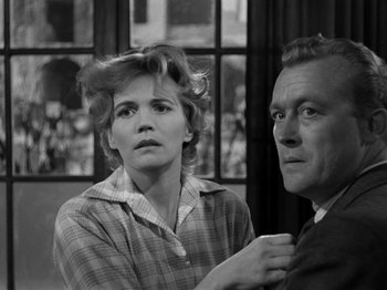 Movie still from “The Devil Strikes at Night” (1957), directed by Robert Siodmak – An older man and a younger woman looking at each other; Medium shot, Low angle
