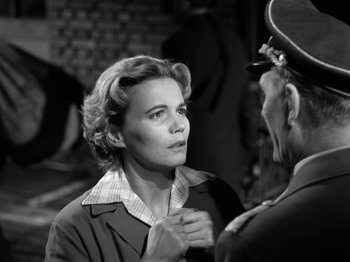 Movie still from “The Devil Strikes at Night” (1957), directed by Robert Siodmak – An old photo of a woman talking to another woman; Close Up shot, Over the shoulder angle
