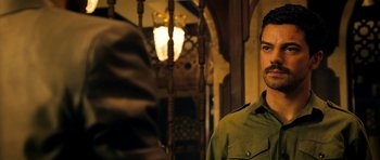 Movie still from “The Devil's Double” (2011), directed by Lee Tamahori – A person wearing a green shirt; Close Up shot, Over the shoulder angle