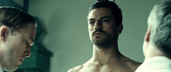 Movie still from “The Devil's Double” (2011), directed by Lee Tamahori – A person in a mirror; Close Up shot, Low angle