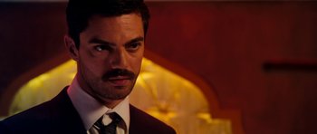 Movie still from “The Devil's Double” (2011), directed by Lee Tamahori – A person wearing a suit and tie; Close Up shot, Over the shoulder angle