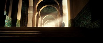 Movie still from “The Devil's Double” (2011), directed by Lee Tamahori – A person walking down a set of stairs in a building; Extreme Wide shot, Low angle