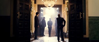 Movie still from “The Devil's Double” (2011), directed by Lee Tamahori – A group of men standing in front of an open door; Wide shot, Low angle